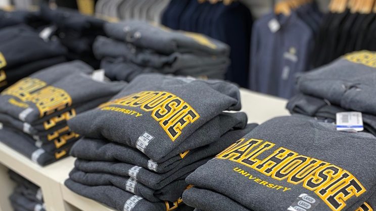 Stack of Dalhousie-branded sweaters for sale.