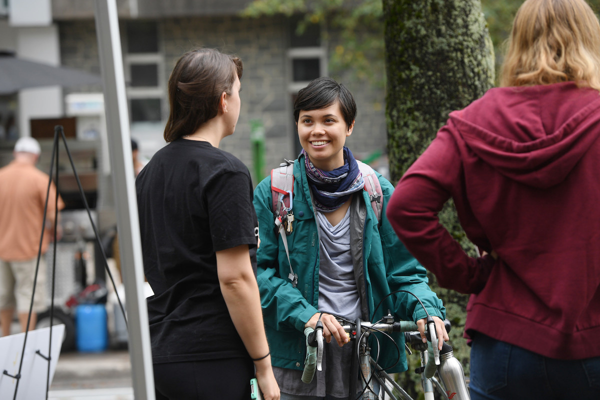 Students gather at a bike lane event on the Dal campus. The student facing the camera is on a bicycle.