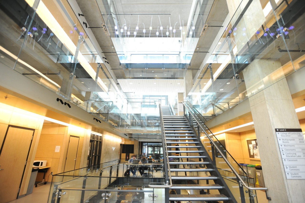 A brightly lit staircase and atrium inside Dal's Mona Campbell Building.