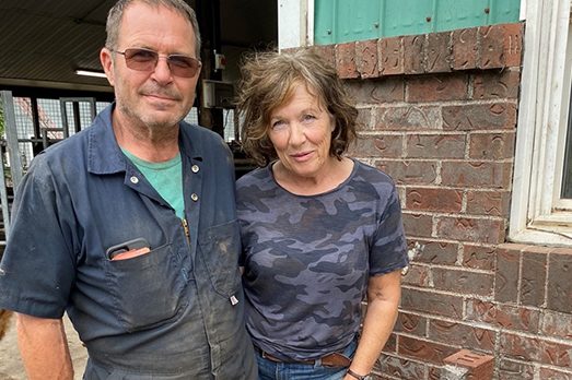 Agriculture alumni and dairy farmers John and Angela Van de Riet standing together at Sunni Knoll Farms.