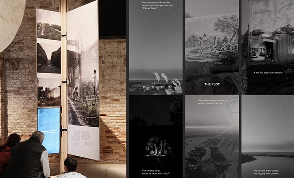 Displays at an architecture exhibit with three people observing the work.