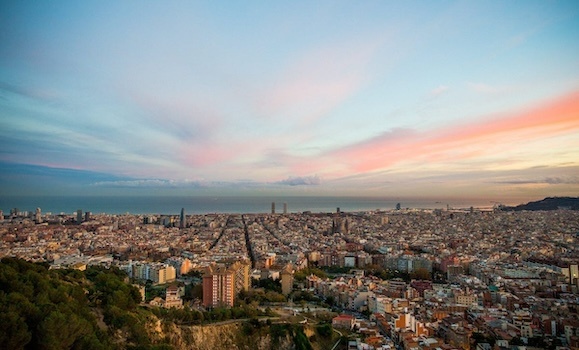 A panoramic view of the city of Barcelona, Spain at sunset. 