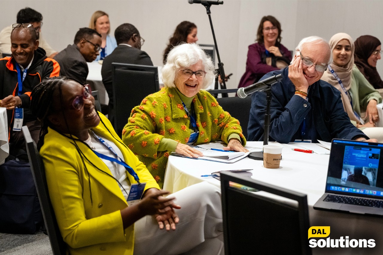 MicroResearch Institute Co-founder Dr. Noni MacDonald at a workshop talks to another female researcher