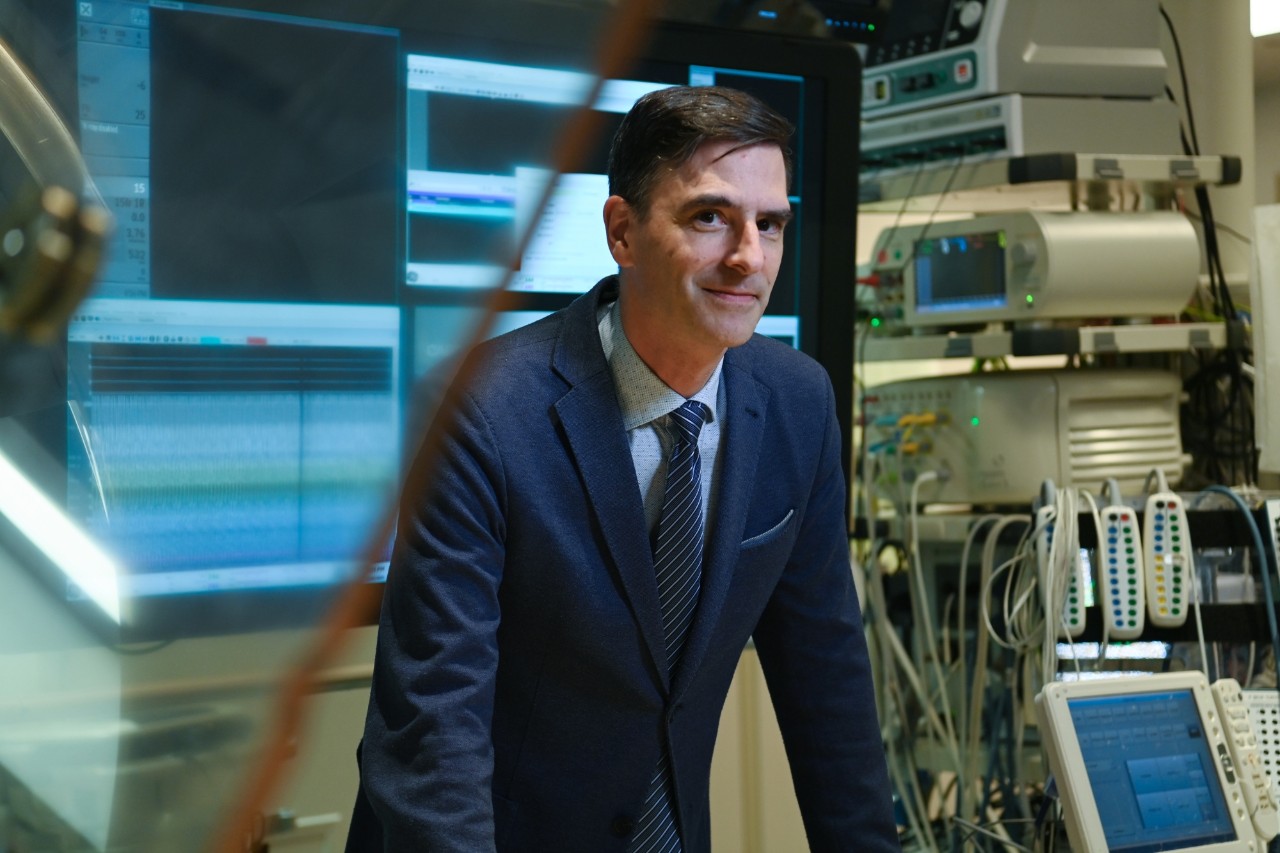 A male doctor in a suit stands in a cardiac surgery suite.