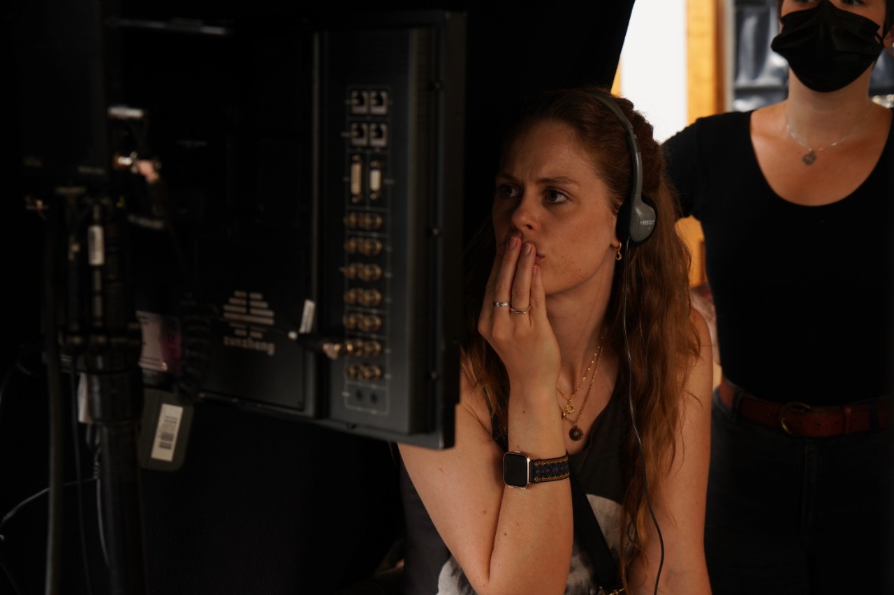 Stagg appearing deep in thought while wearing a headset and viewing a screen.