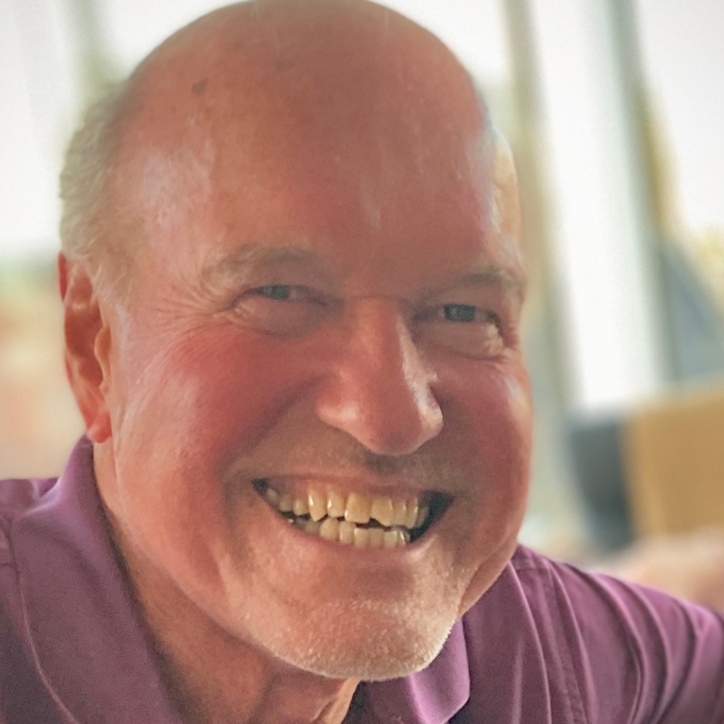 Portrait of Tom Lynch smiling.