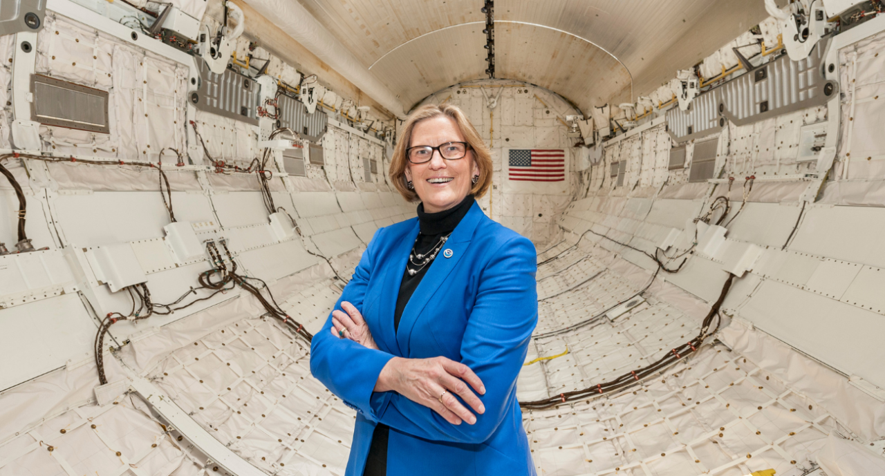 Dr. Kathryn Sullivan stands insight the Space Shuttle Discovery.