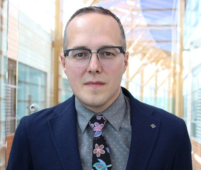 Mushquash in business formal attire.