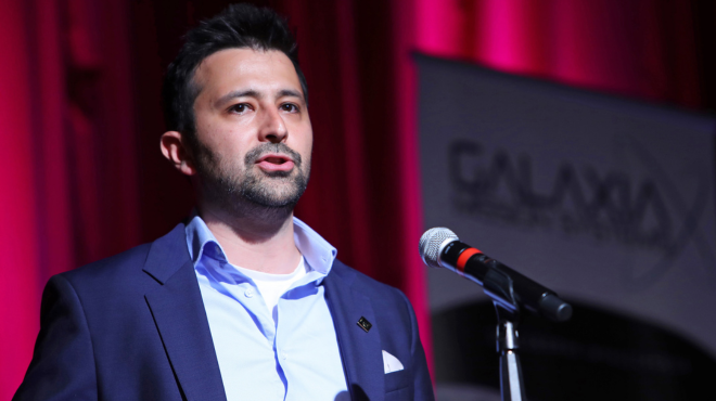 Gharagozli is presenting at an event.