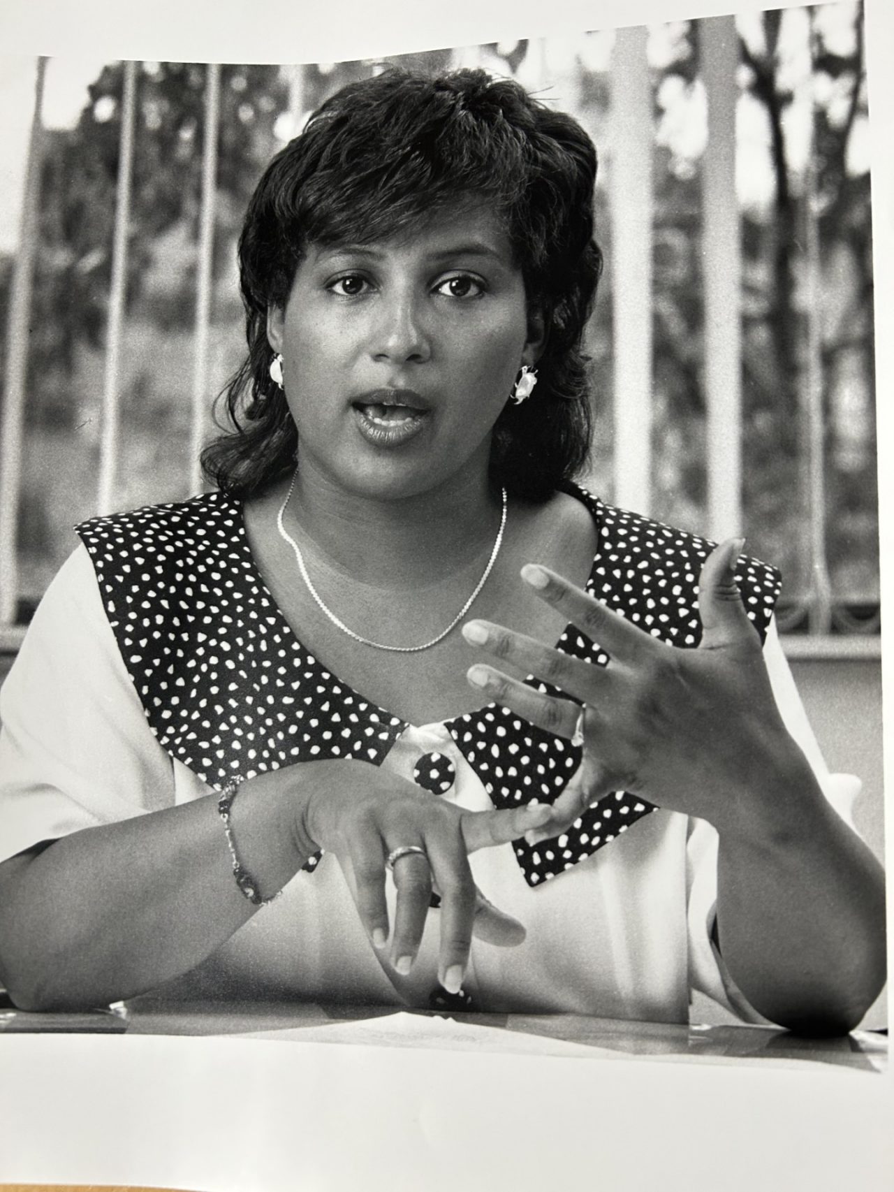 A newspaper-style photo of a woman in the 1990s.
