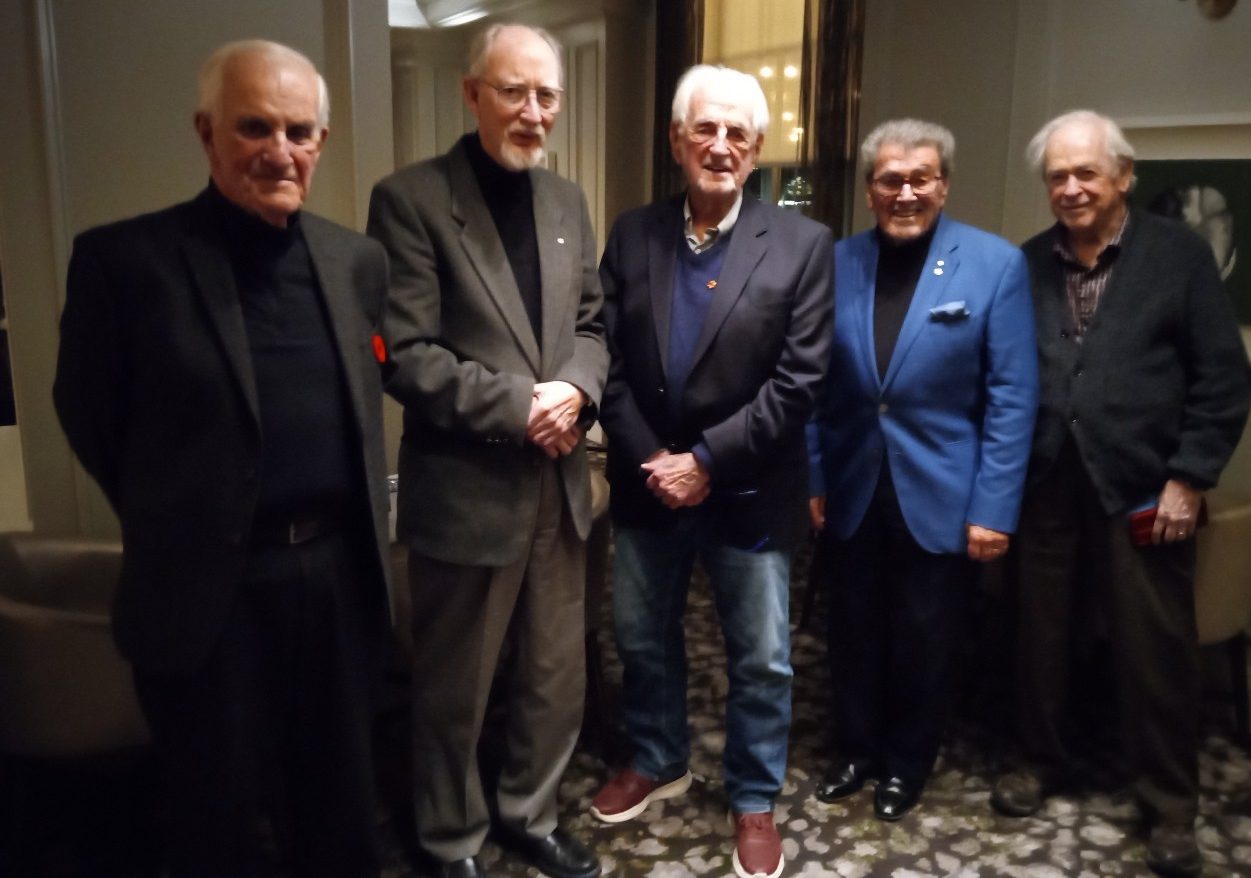 Five male-identifying alumni of the Dal Medicine class of 1963 wearing suit jackets pose together at an event.