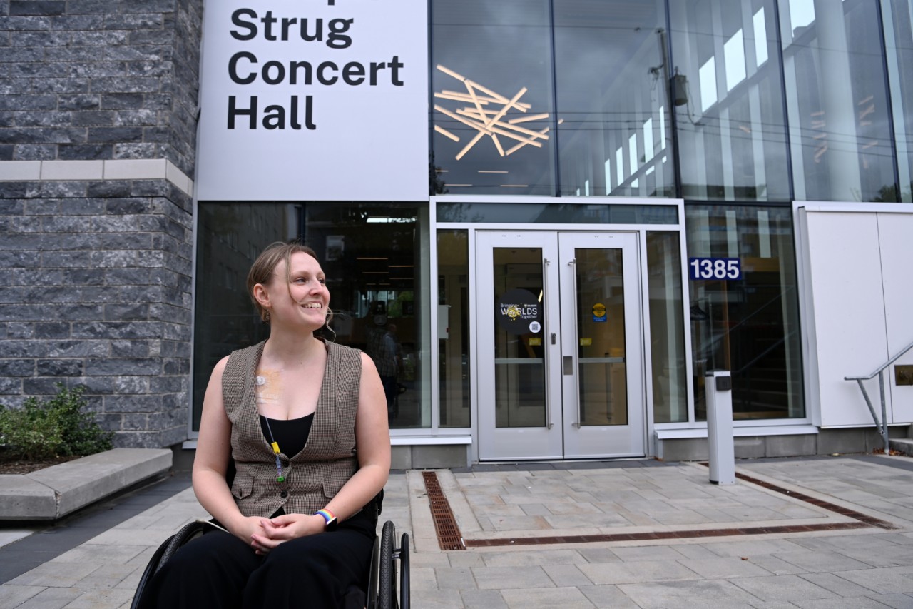 Taverner in a wheelchair smiles outside the Strug Concert Hall.