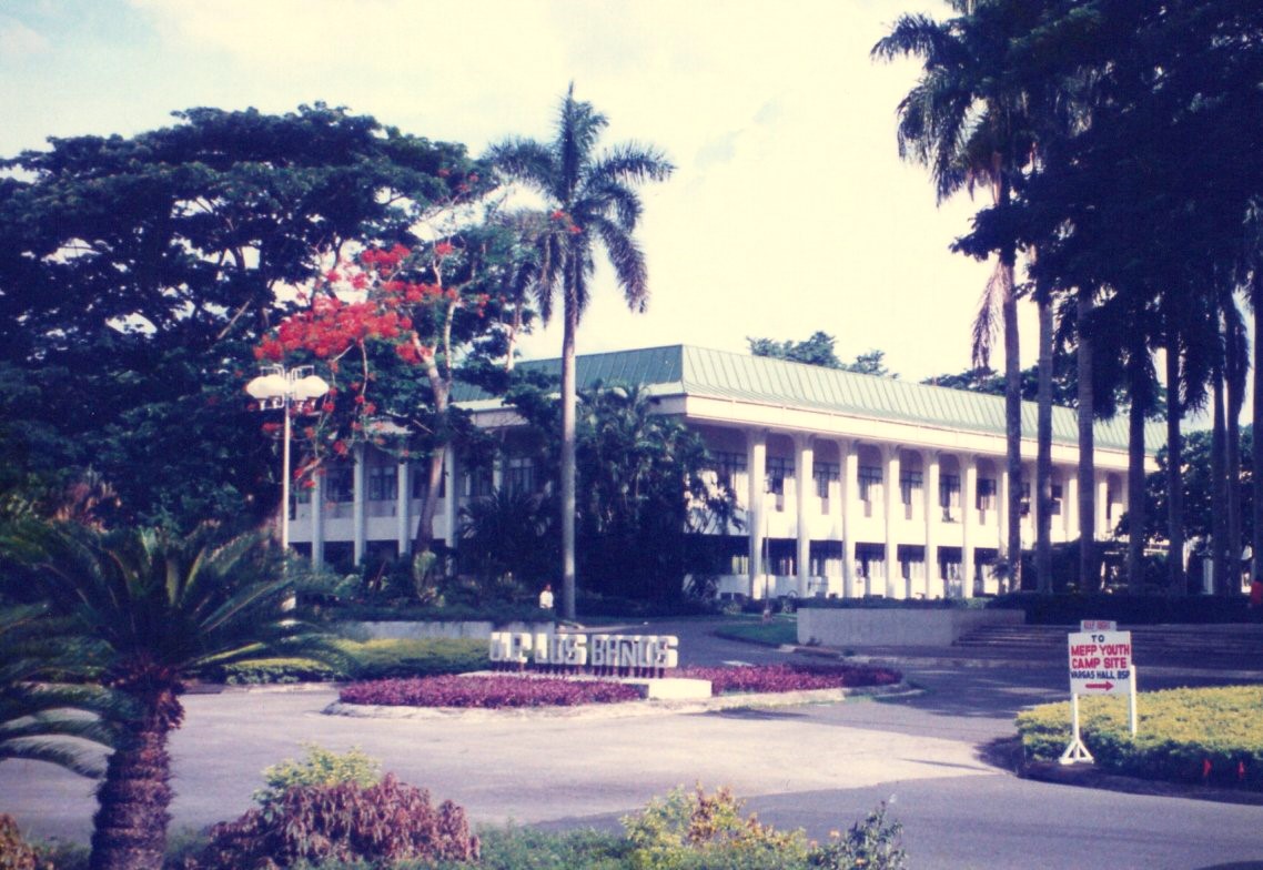 A building is nestled among tropical trees on a university campus in the Philippines in 1994.