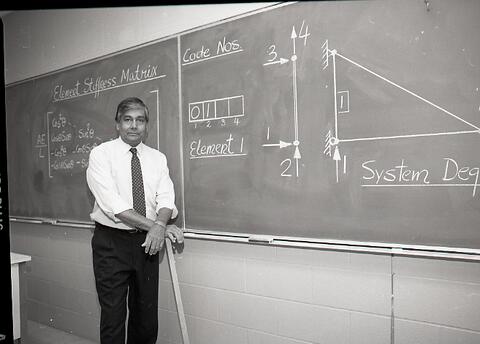 Civil Engineering Professor Dr. Mel Hosain standing at a blackboard.