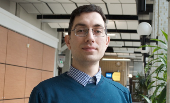 Faramarz Jalili portrait in the hallway of a health building.
