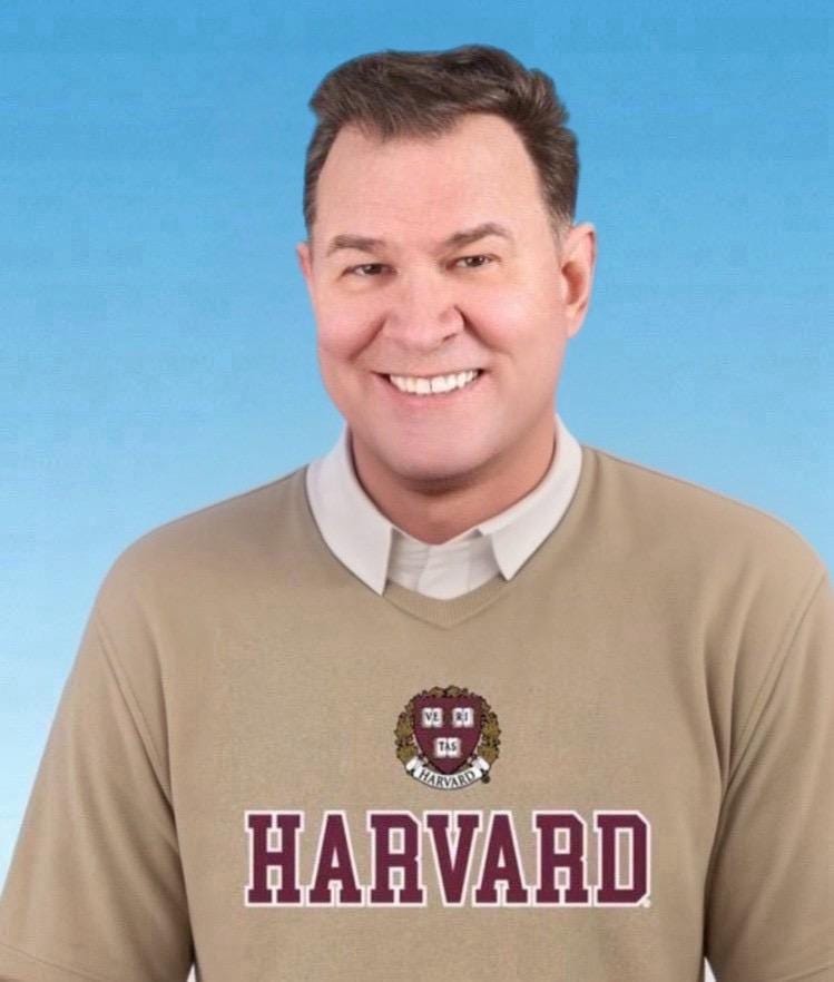 Thompson wearing a Harvard sweater.