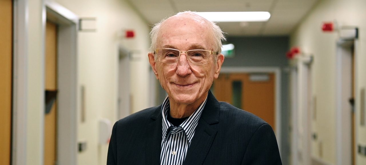 Don Hill stands in a hospital corridor in a suit jacket.