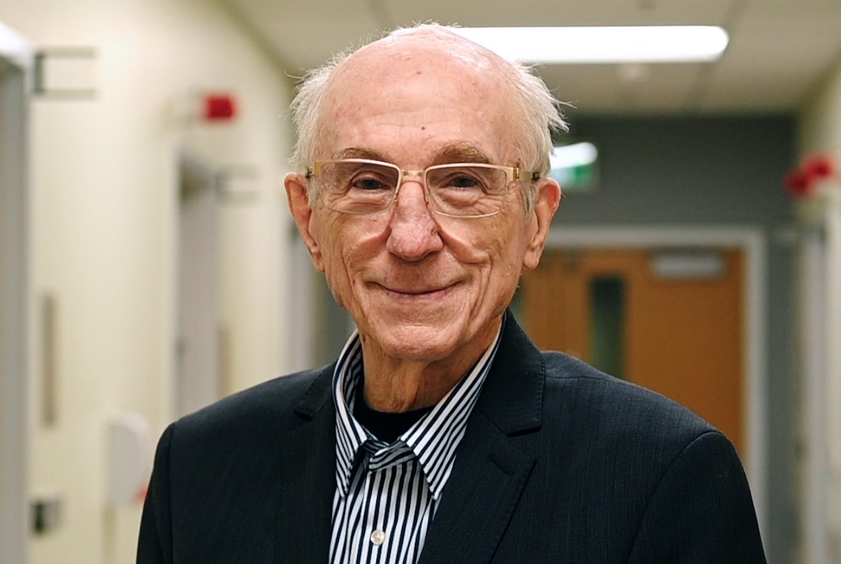 Don Hill stands in a hospital corridor in a suit jacket.