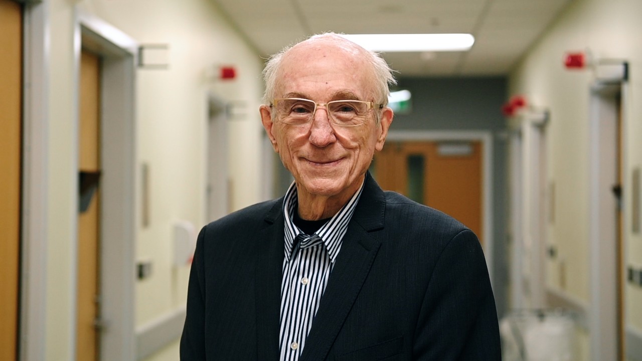 Don Hill stands in a hospital corridor in a suit jacket.