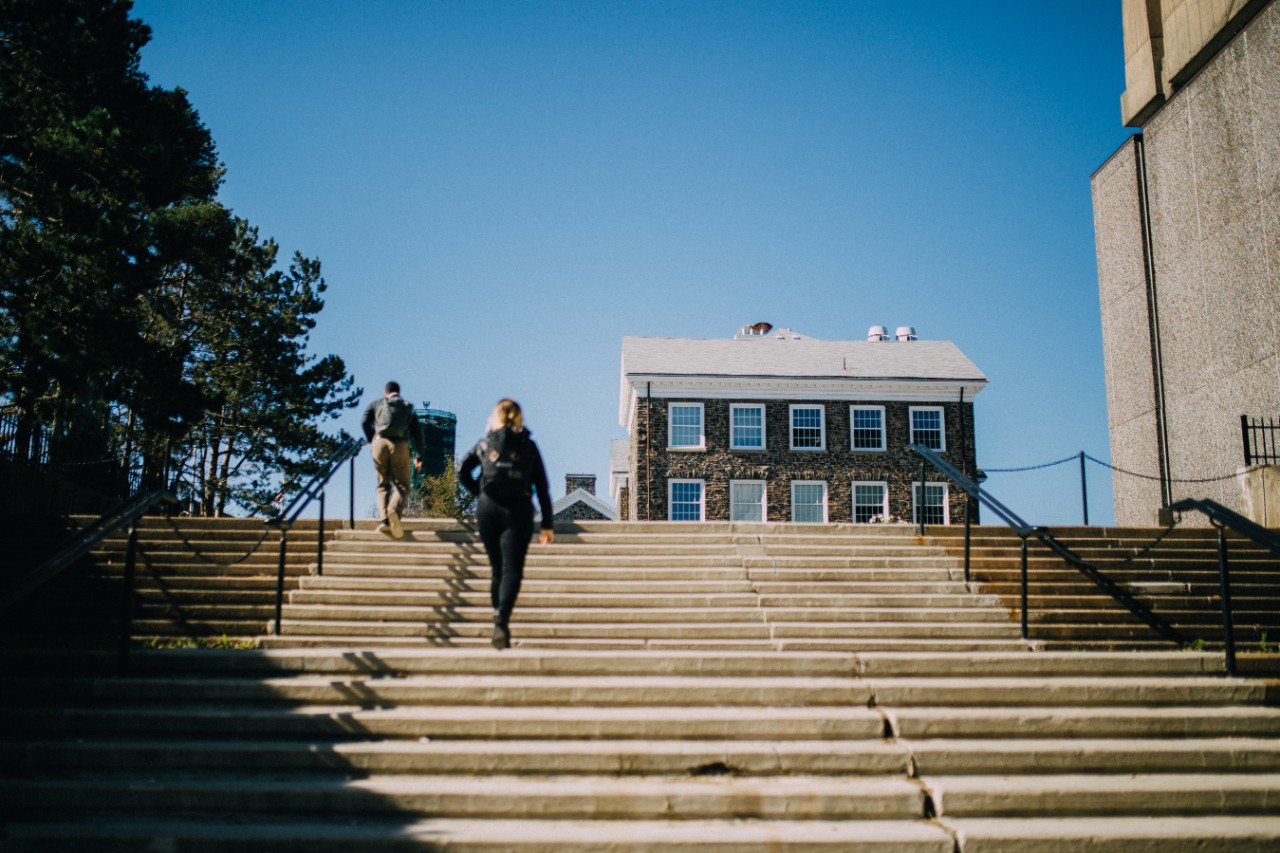 Student walking up the stairs on Studley Campus