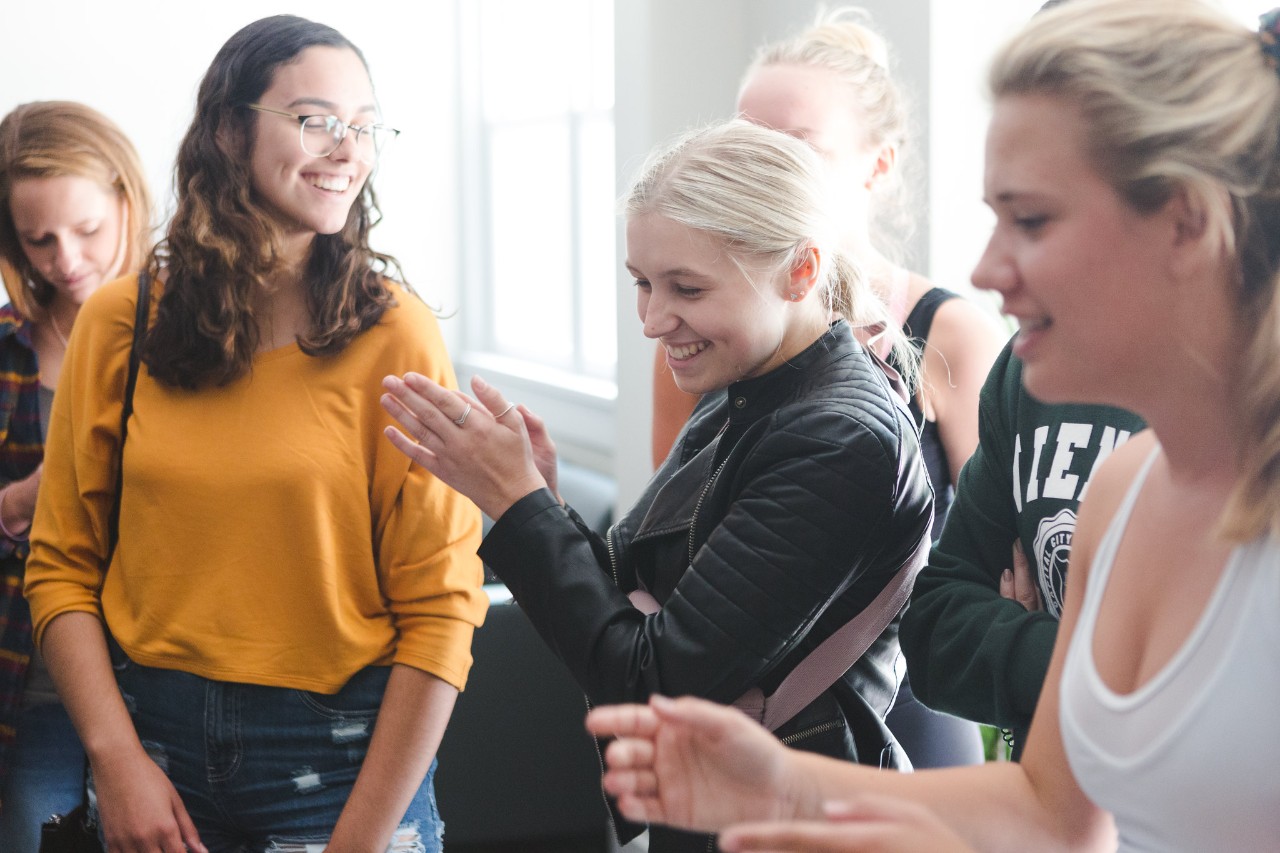 group of students cheering and clapping