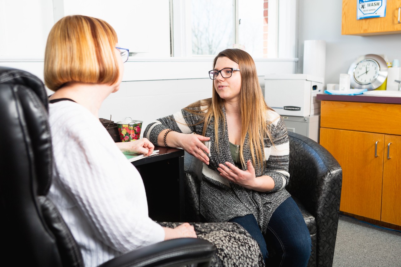 Nurse and student talking in health centre