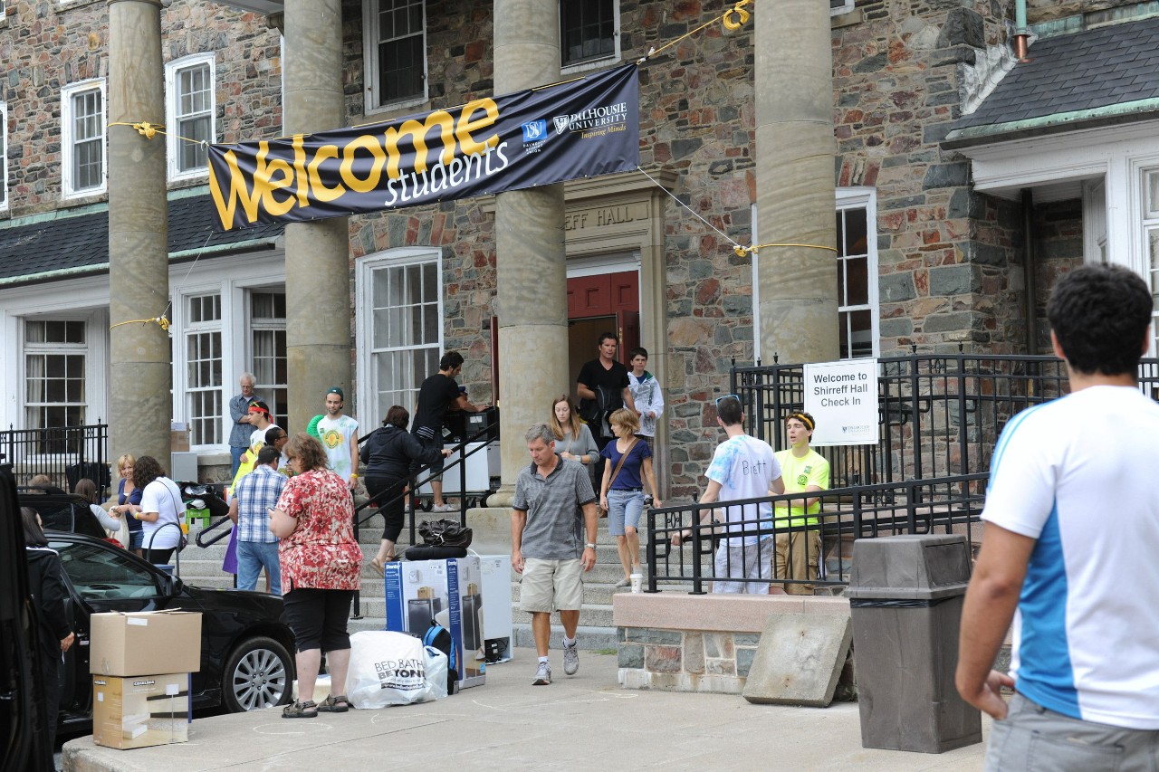 Students move into Shirreff Hall, carrying their belongings up the front steps.