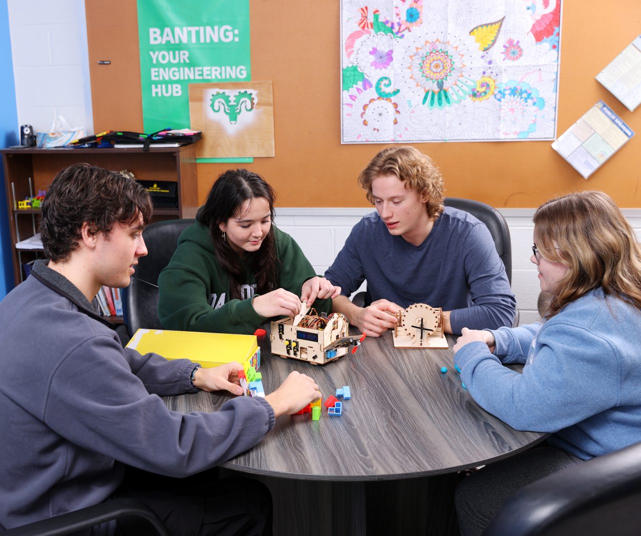 students working on a project together around a table