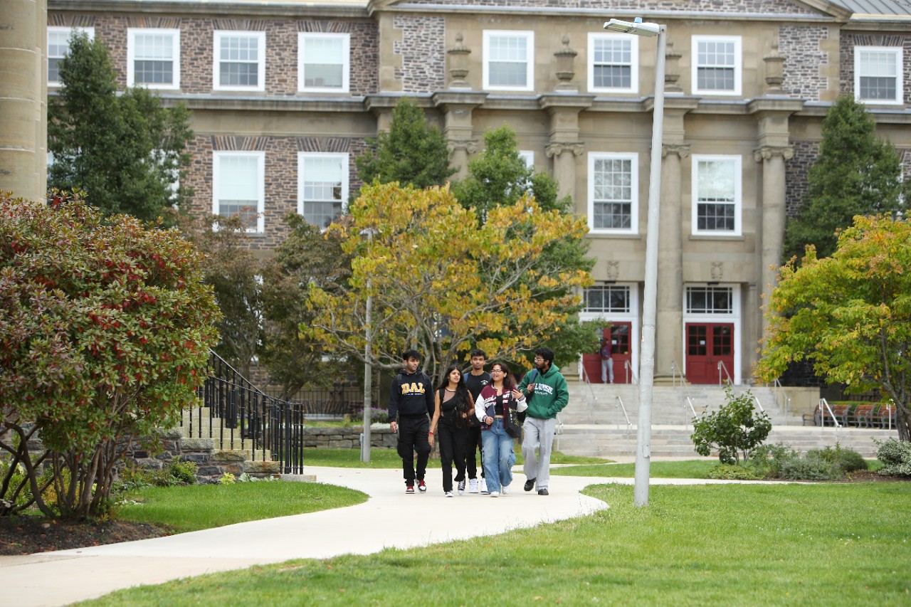 group of student walking in front of bulding on campus