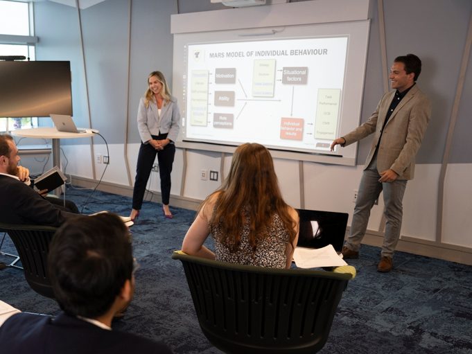 business students giving a presentation to their class