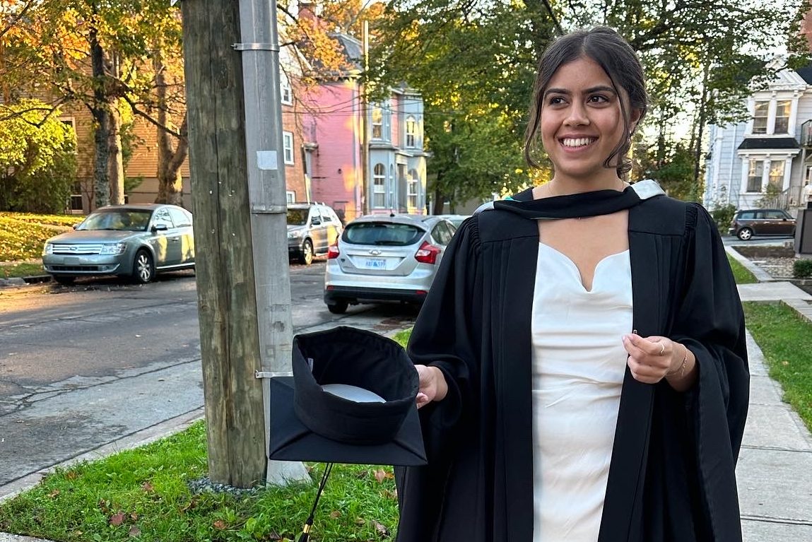 Deeksha Sareen in her convocation gown and holding her cap