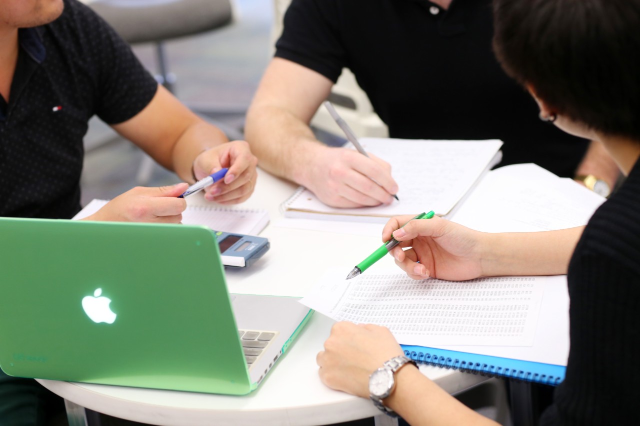 A group of four students works together at a table
