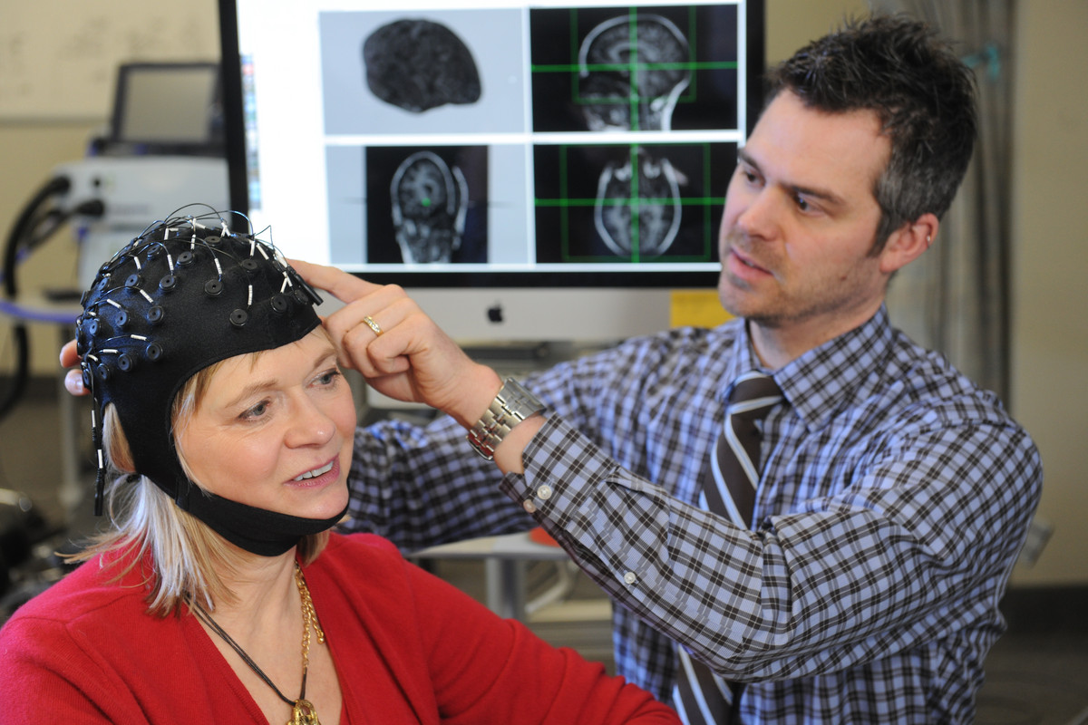A person wears a cap allowing her brain to be measured