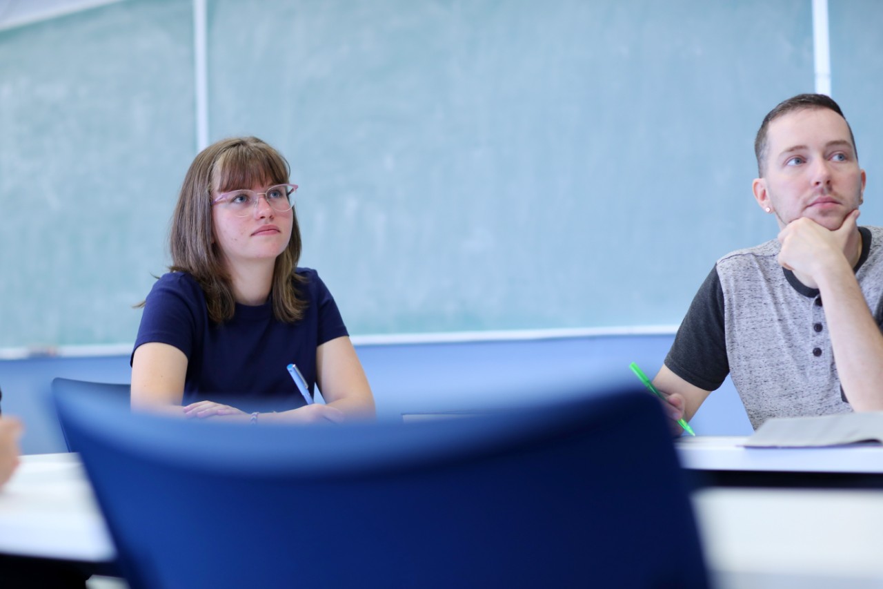 Dalhousie Science students sit in front of a chalk board while attending a lecture