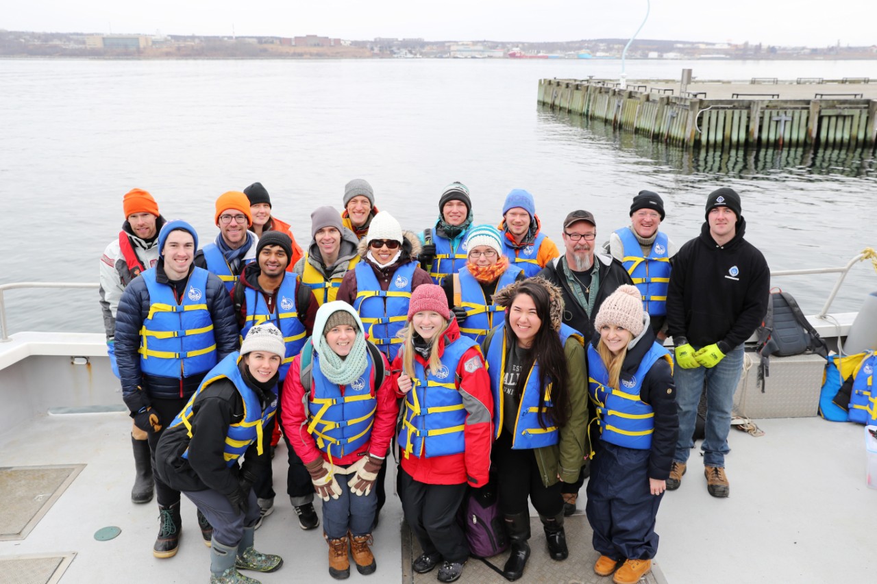 Oceanography students pose in a group during an outing on the water