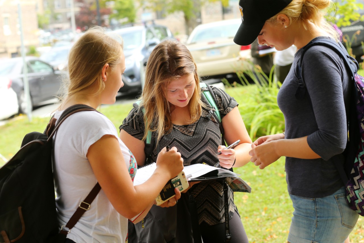 Students compare notes while during field work