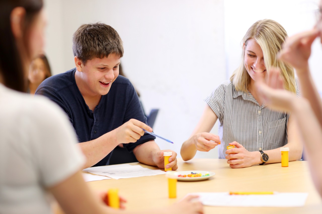 Students laugh while participating in a psychology experiment