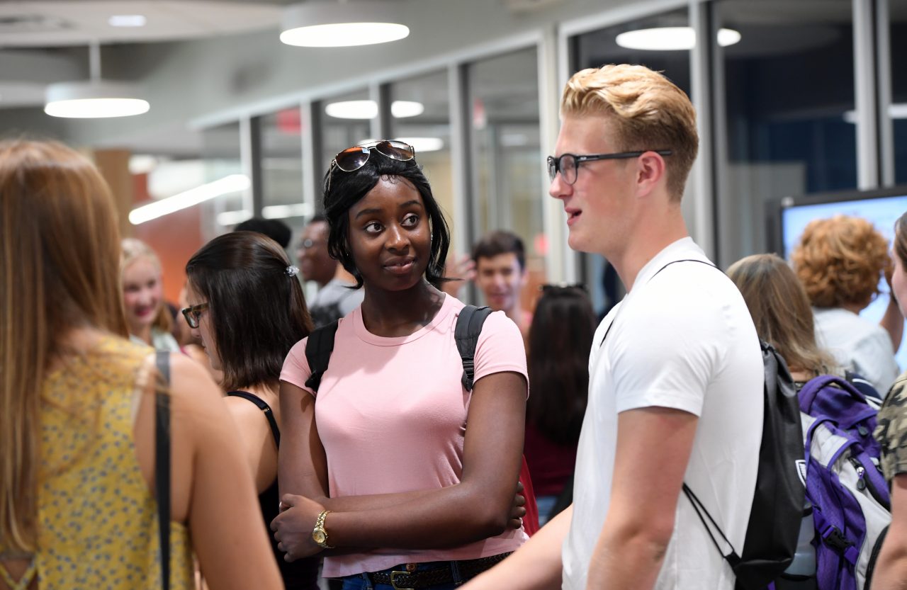 Students and faculty have a conversation while attending the Dalhousie Science welcome party