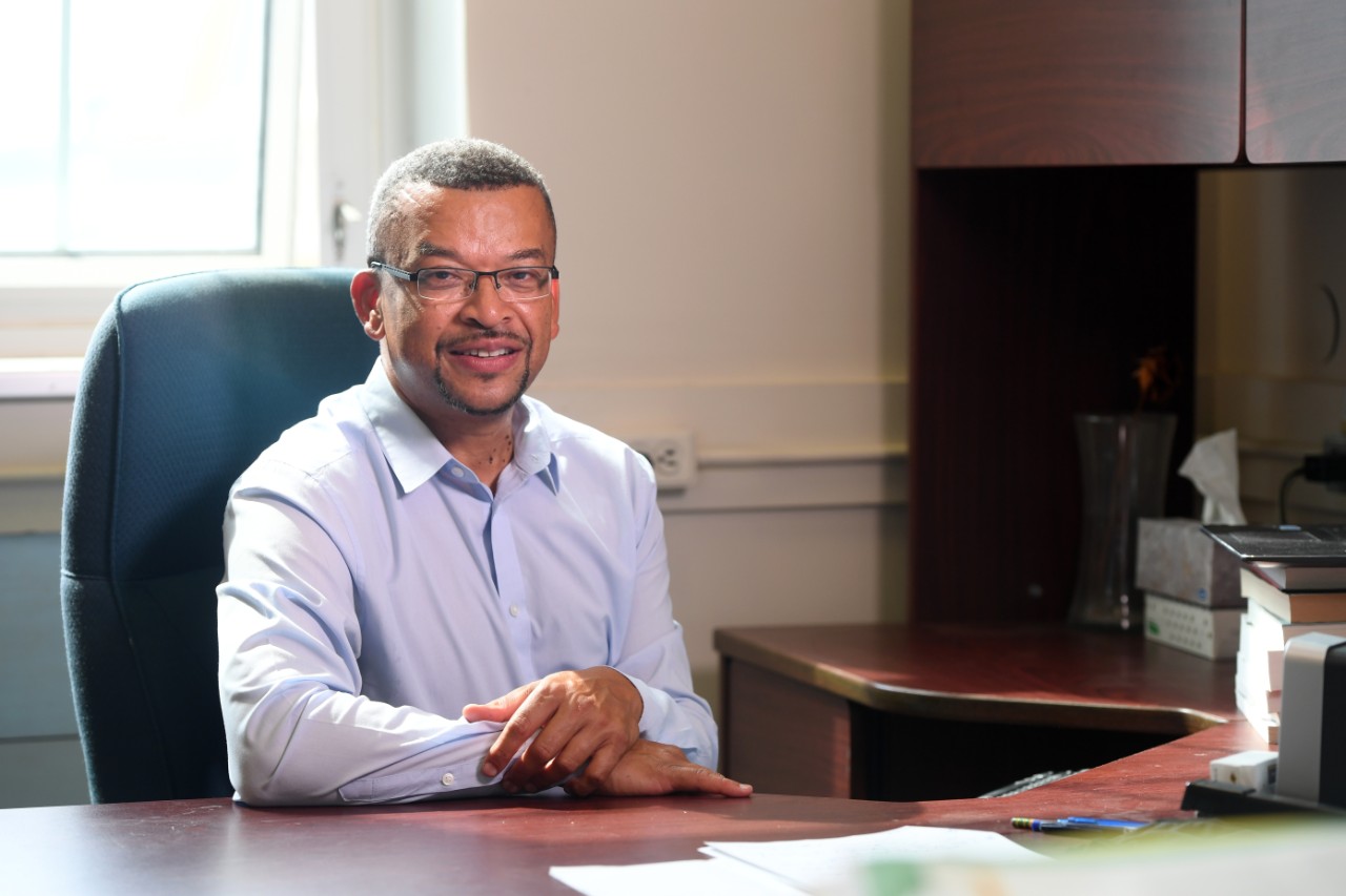 Dr. Kevin Hewitt sits at his desk in the Sir James Dunn Building