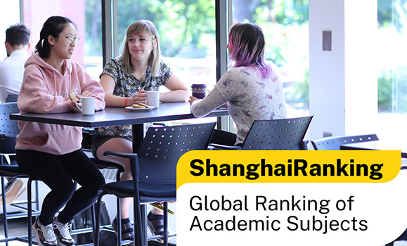 3 students sit at a table in a classroom with overlayed text that says Shanghai Rankings: Global Rankings of Academic Subjects