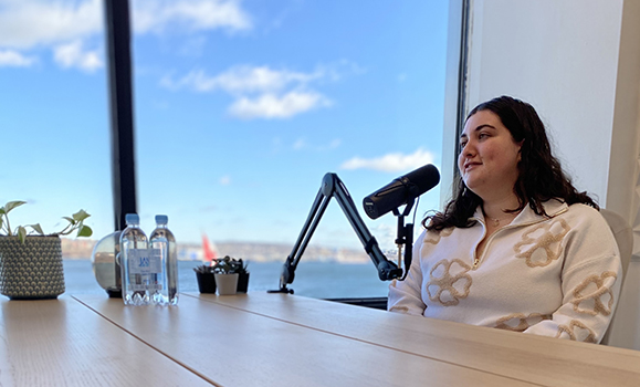 Two people record a podcast in a studio 