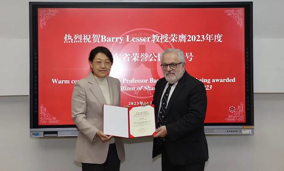 Dal's Dr. Barry Lesser receives an award from the vice president of the Shandong University of Finance and Economics