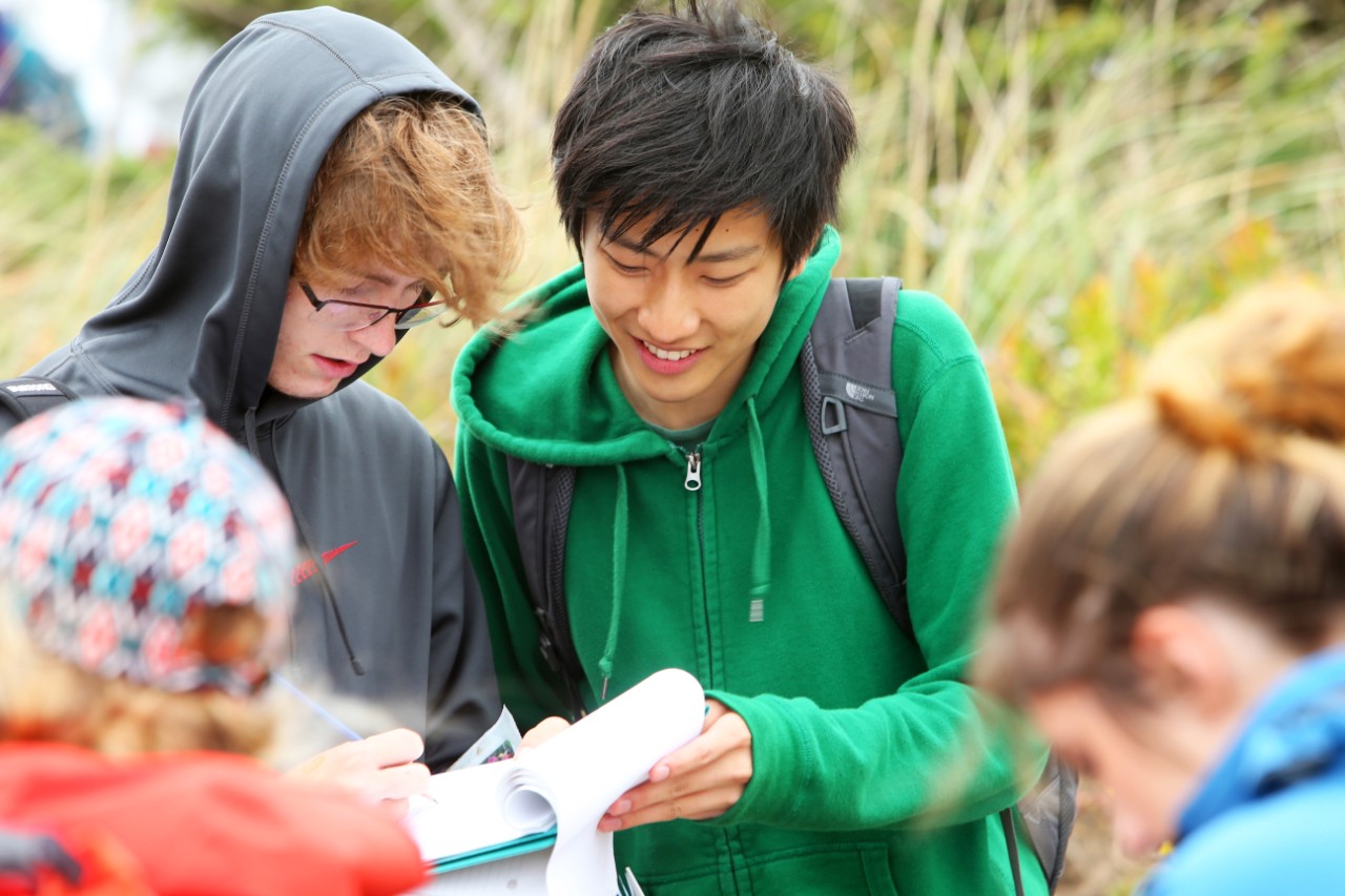 Science students compare notes while they attend a field trip at Conrad's Beach, Nova Scotia