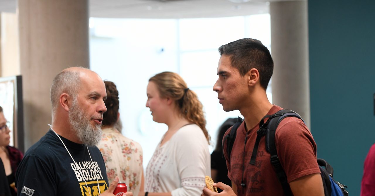 A student and faculty member have a conversation while they attend the Dalhousie Science welcome party