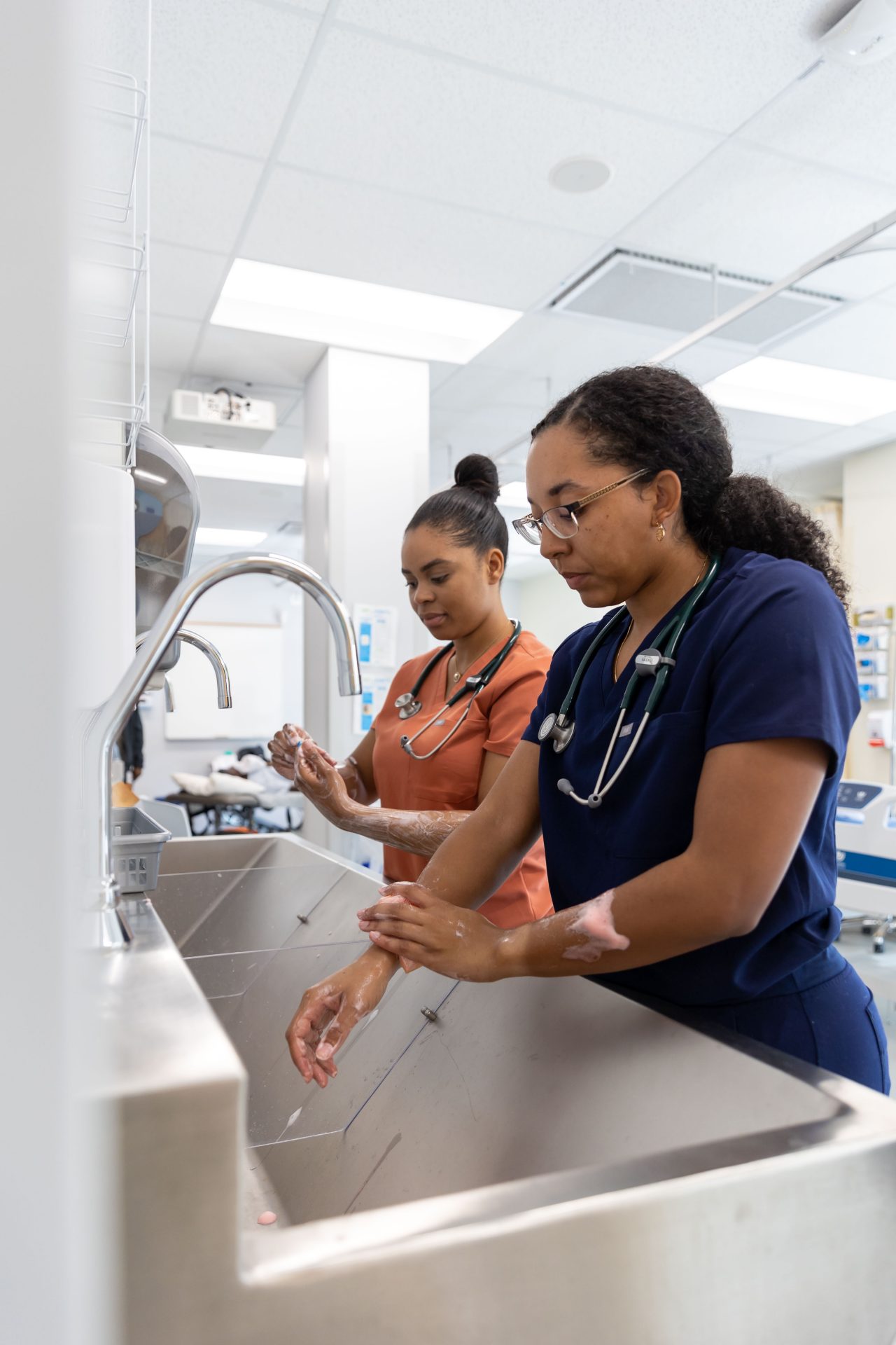 two medical staff wash their hands