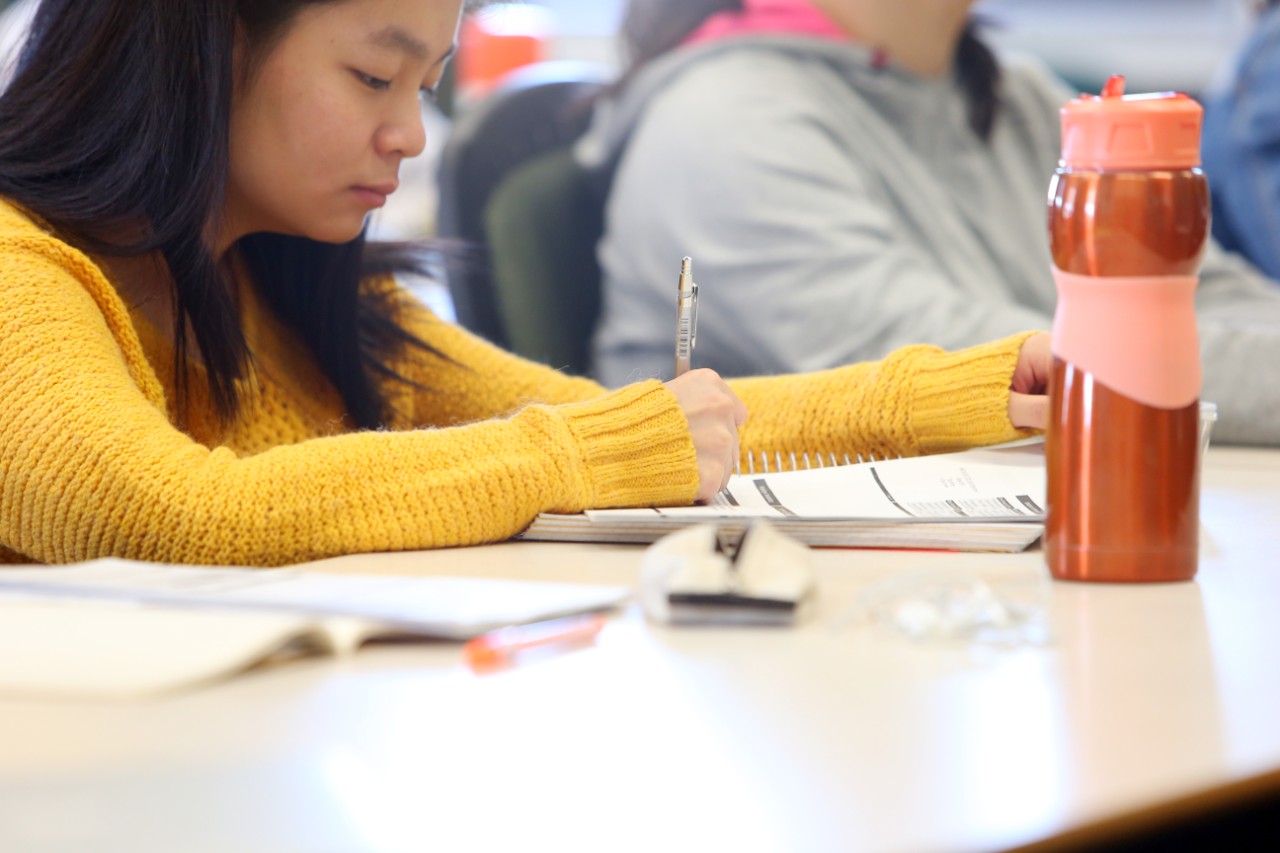 Student wearing a yellow sweater studying in the Department of Mathematics and Statistics
