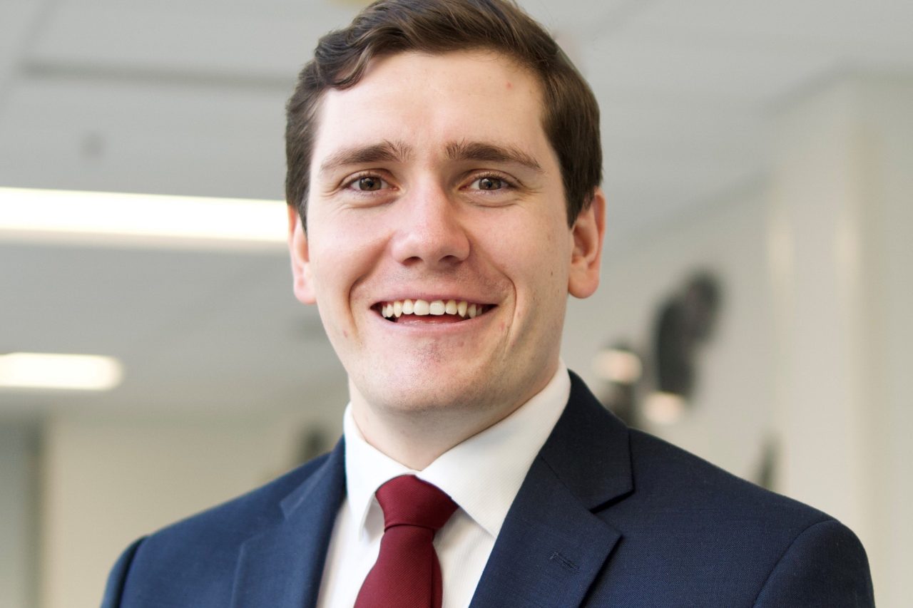 Mark O'Reilly wearing a blue suit with a red tie