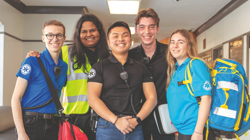 A group of people wearing EMT shirts and equipment