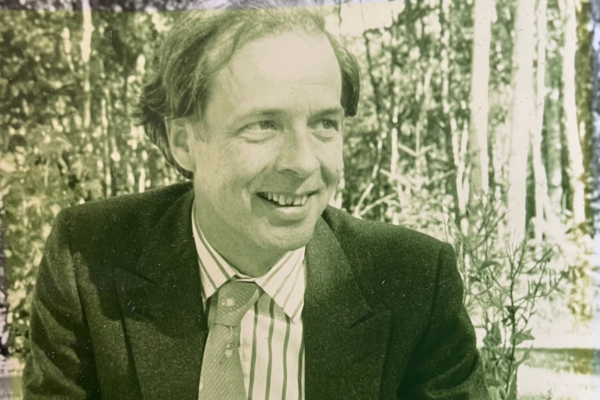 A black and white picture of a man wearing a suit