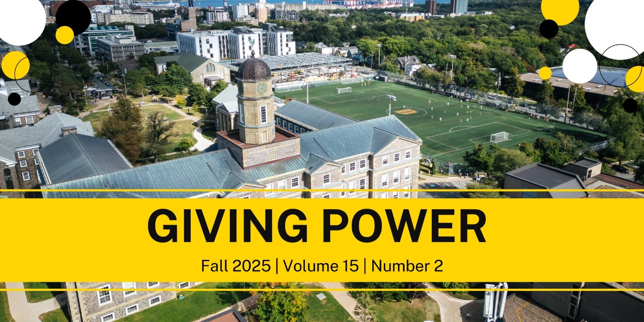Aerial view of campus with field and buildings in summer.